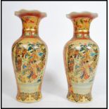 A pair of 20th century Chinese export ware famille rose vases decorated with typical scenes and of
