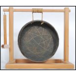 A 20th century wooden framed table / dinner gong, set within a pine wooden frame having a