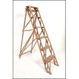 An early 20th century wooden trellis - lattice worked Industrial step ladder. Ideal as conversion to