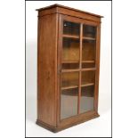A 19th century Victorian oak bookcase raised on a flared plinth base having a quarter panelled