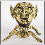 A 19th century brass treen match strike, the match strike in the form of a grotesque Pixie / Imp,