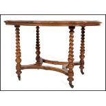 A 19th century Victorian walnut library table raised on brass castors with barley twist columns