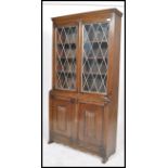 A mid century Regency revival solid oak library bookcase cabinet. Twin astragal glazed display