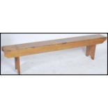 A 19th century pine refectory pig bench. Raised on