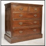 An Edwardian mahogany chest of drawers being raised on a plinth base with 2 short over 3 deep