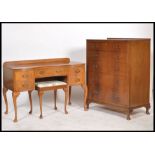 A mid 20th century walnut dressing table raised on  cabriole legs with triptych mirror atop,