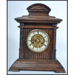 A vintage 20th century HAC wooden cased mantle clock having a columned hood. The enamel face