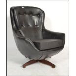 A vintage Scandinavian Parker Knoll black faux leather swivel button back pod armchair with five