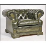 A 20th century Chesterfield green leather button back club armchair, low back with scroll arms.