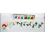 A collection of vintage / retro kitsch to include a set of six multi coloured napkin rings, a set of