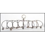 A 19th century silver plate expanding metamorphic toast rack. Raised on bun feet with a scissor