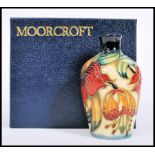 A Moorcroft ceramic vase tube lined decorated with flowers complete in original box C98 mushroom