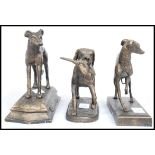A collection of three cast metal bronze effect figurines of dogs to include a bitch and a dog