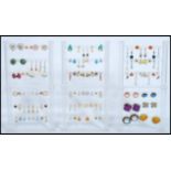 A large collection of costume jewellery earrings to include yellow and white metal examples being