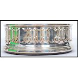 A continental silver hallmarked W I Broadway & Co silver and  turned wood wine coaster. Fret pierced