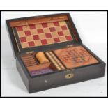 A 19th century games compendium set housed within a wooden case to include chess, draughts,