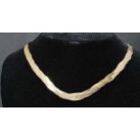 A 9ct gold vintage multi strand wave link necklace chain having a lobster claw clasp. Weighs 11.2