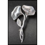 A 925 silver Art Nouveau style figural brooch in the form of  a flower spray  having a roller clip