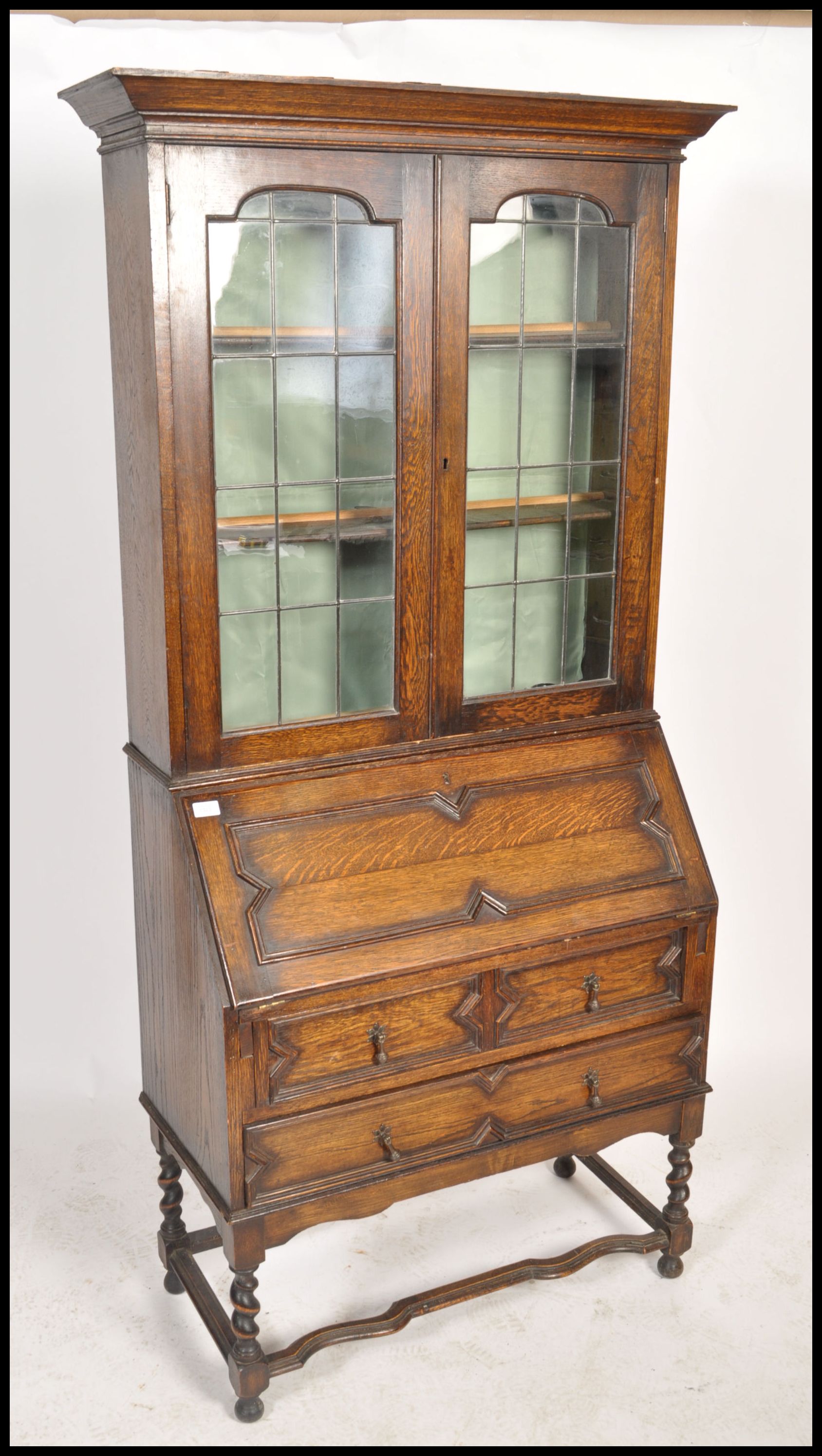 An early 20th century oak Jacobean revival bureau bookcase. Raised on barley twist supports with - Image 2 of 5