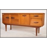 A vintage mid century teak wood sideboard in the Danish manner having 2 angular drawers to the