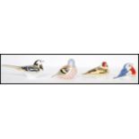 A collection of four Royal Crown Derby paperweights to include Chaffinch, Goldfinch, Anniversary