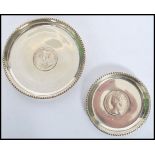 two silver white metal peanut dishes / coasters, each with a bead work border and a centrally