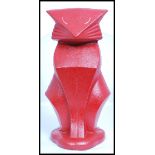 A vintage Art Deco style cast metal door stop in the form of a stylised Art Deco seated cat,