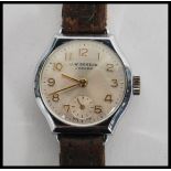 A vintage 20th century J.W. Benson of London wrist watch. The silvered dial having faceted hands and