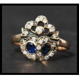 A 9ct gold sapphire and diamond sweetheart  ring having two sapphire set hearts surrounded by a halo