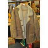 A vintage 20th century hip length gents sheepskin coat approximately size 46, slightly torn to one