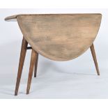 An Ercol retro 1970's drop leaf circular coffee - occasional table by Ercol raised on tapered legs w