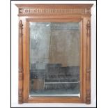 A 20th century French walnut large overmantel mirror with carved columns to the side and cornice