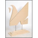 A contemporary handmade advertising point of sale swan sculpture constructed of panel wood and