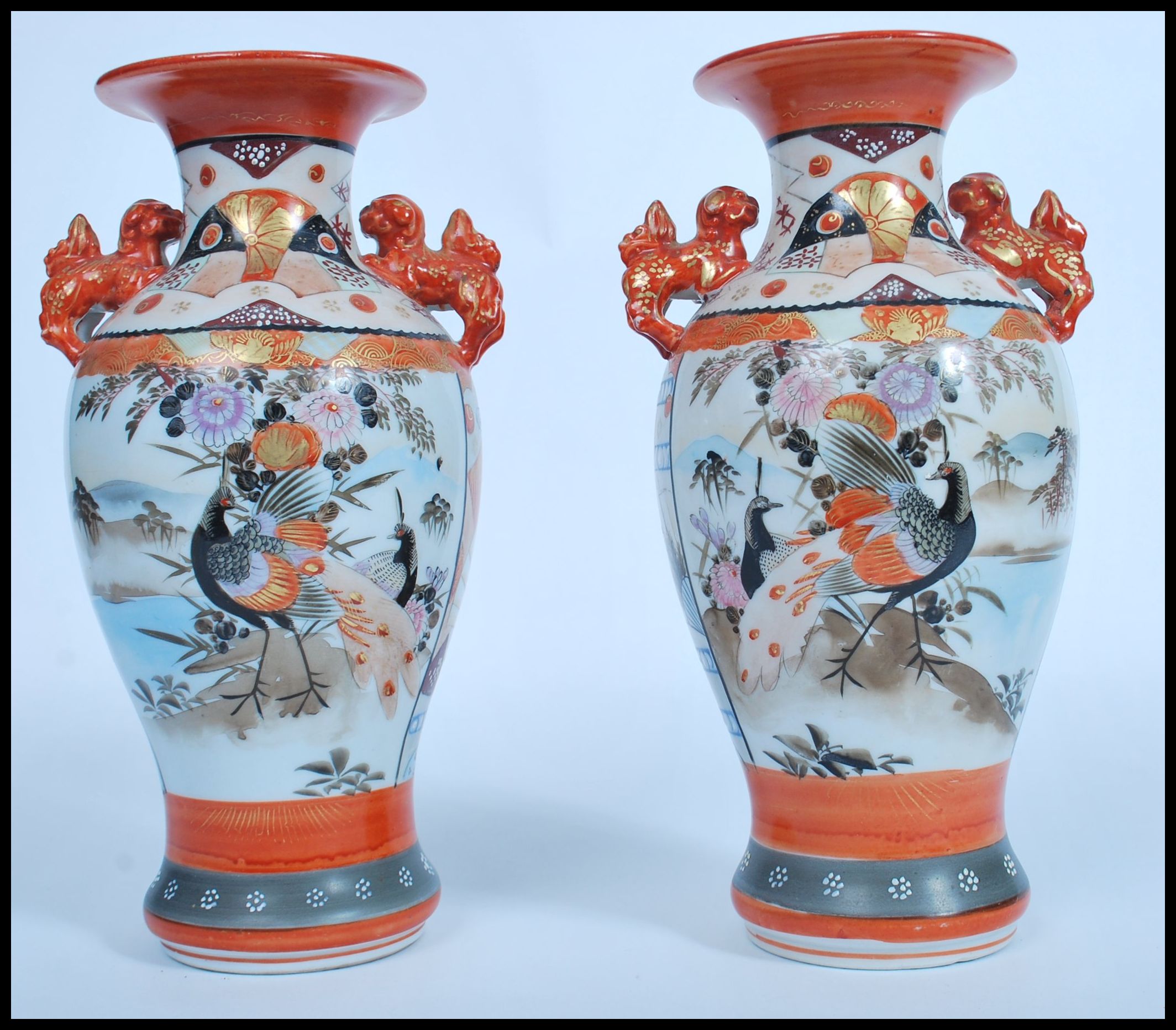 A pair of Japanese Kutani vases, Meiji, with twin handles modelled as dogs of fo, the panels
