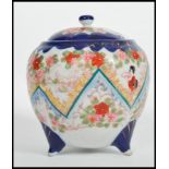 A vintage early 20th century Japanese ceramic lidded biscuit barrel having painted floral decoration