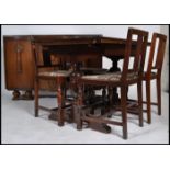 A 1940's oak draw leaf refectory extending dining table together with a set of 4 matching dining