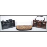 A collection of three ladies snakeskin handbags clutch bags to include examples by Ackery of
