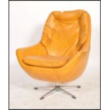 A retro 1960's - mid century vivid orange faux leather swivel armchair of angular form being