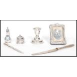 A collection of silver hallmarked items to include a pepper cruet, candle stick, easel picture