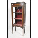An early 20th century Edwardian inlaid mahogany display cabinet, fitted with a pair of glazed