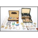 A good collection of costume jewellery contained within two jewellery boxes to include silver items,