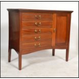 An Edwardian mahogany music cabinet being raised on square tapered legs with a bank of 5 fall