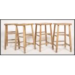 A set of 4 retro 20th century Industrial lab - laboratory stools raised on turned legs with