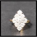 A hallmarked 18ct gold and diamond ring. The nine round cut diamond stones being approx 20pnts and