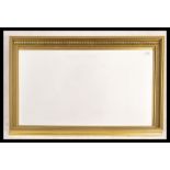 A 20th century contemporary wall mirror of rectangular form having a decorative gilt frame with a