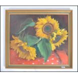 A 20th century still life oil on canvas painting of sunflowers set within a gilt frame and signed to