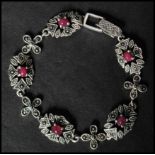 A 925 silver  Art Nouveau style bracelet set with ruby cabochons and marcasite having a clip