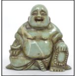 An Oriental Chinese carved soapstone seated laughi