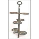 A vintage 20th century cast iron garden planter stand having six circular branches with a pierced