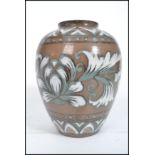 An Oriental Chinese / Japanese stoneware vase having hand painted foliage with character stamp to